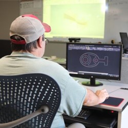 Student working on a computer in a classroom.